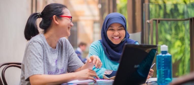 Students working together with a laptop.