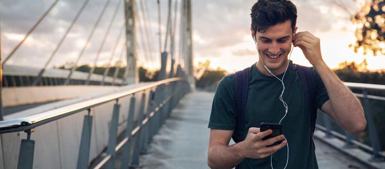 Student walking across bridge